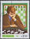 Cancelled postage stamp printed by Nicaragua, that shows Chess, Early In The Game And Thinking About The Game
