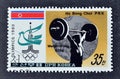 Cancelled postage stamp printed by North Korea, that shows Weight lifting