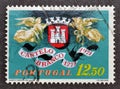 Cancelled postage stamp printed by Portugal, that shows Coat of Arms between two angels Royalty Free Stock Photo