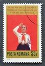 Cancelled postage stamp printed by Romania, that shows Female Young Pioneer saluting