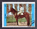 Cancelled postage stamp printed by Sharjah and dependencies, that shows Horse riding