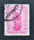 Cancelled postage stamp printed by Syria, that shows Bronze vase in form of African woman