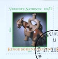 Cancelled postage stamp printed by United Nations, that shows Mochican stirrup-spouted vessel in the form of a llama