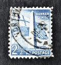 Cancelled postage stamp printed by USA, that shows Bunker hill monument and flags