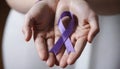 Cancer Awareness Day concept,girl holding purple cancer awareness ribbon close up Royalty Free Stock Photo