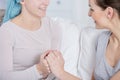 Cancer patient and her friend holding hands Royalty Free Stock Photo