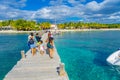 CANCUN, MEXICO - JANUARY 10, 2018: Beautiful outdoor view of unidentified tourist walking over a wooden pier in the Isla