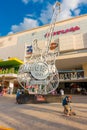 CANCUN, MEXICO - JANUARY 10, 2018: Unidentified people at outdoors next to Hard Rock Cafe metallic guitar structure in