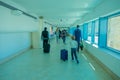 CANCUN, MEXICO - JANUARY 10, 2018: Unidentified people walking carrying their luggages in a hall inside of the Cancun