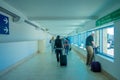 CANCUN, MEXICO - JANUARY 10, 2018: Unidentified people walking carrying their luggages in a hall inside of the Cancun