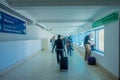 CANCUN, MEXICO - JANUARY 10, 2018: Unidentified people walking carrying their luggages in a hall inside of the Cancun