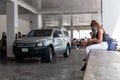 Cancun. Quintanaroo, Mexico. 08.17.2020 Real woman wearing a protective mask while waiting for a rental car to be delivered to her Royalty Free Stock Photo