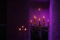 Candelabra with candles in purple backlit background