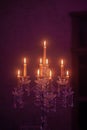 Candelabra with candles in purple backlit background