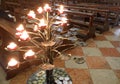 candelabrum with many lighted candles inside the church Royalty Free Stock Photo