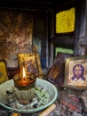 Candelakia - traditional miniature Church by the road in the forest with a burning candle and icons inside on island Evia in Greec