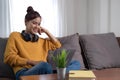 Candid of asian woman using laptop for watching online movie stream mobile device on sofa at living room. Young happy Royalty Free Stock Photo