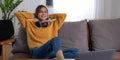 Candid of asian woman using tablet for watching online movie stream mobile device on sofa at living room. Young happy Royalty Free Stock Photo