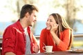 Candid couple in love flirting in a terrace