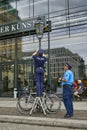 German Police or Polizei attaching no parking notice on a lamp pole near the US Embassy in Berlin, Germany