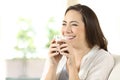 Candid girl drinking cocoa shake at home