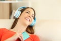 Candid girl wearing headphones listening to music