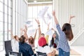 Candid group of young creative team employee prople throwing documents paper and feeling happy after work success at working place