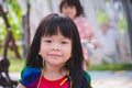 Candid image child 3-4 years old. Face sweet smile little girl in park playground. Head shot happy adorable kid Summer or spring