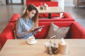 Candid image of young woman using tablet computer in a cafe Royalty Free Stock Photo