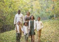 Candid Mixed Race family portrait outdoors with autumn colors