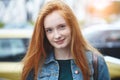 Outdoor portrait of pretty smiling red haired young girl Royalty Free Stock Photo