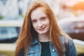 Candid outdoor portrait of pretty smiling red haired young girl Royalty Free Stock Photo