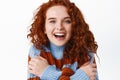 Candid people and real emotions. Beautiful redhead girl with curly natural hair and clean healthy facial skin, hugging