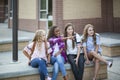 Group of Teenage girls laughing and talking together at school Royalty Free Stock Photo