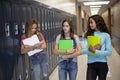 Group of teenage girls walking together in the hallway at junior high school Royalty Free Stock Photo