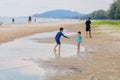 Candid photo oh little chidren playing together at Hua Hin Beach on holiday. Hua Hin, Thailand October 14, 2017