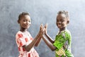 Candid Photo of Two African Children Sisters Girls Women Playing Cheerful Smile with Hands and Faces Royalty Free Stock Photo