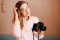 Candid portrait of beautiful blonde girl woman photographer with her camera at work Royalty Free Stock Photo