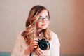 Candid portrait of beautiful blonde girl woman photographer with her camera at work Royalty Free Stock Photo