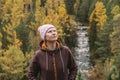 Candid portrait of a beautiful middle-aged woman against the background of an autumn forest. Selective focus. Close-up