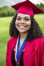 Portrait of a beautiful multiethnic woman in her graduation cap and gown