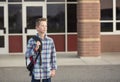 Elementary school student standing outside the school building Royalty Free Stock Photo