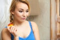 Candid portrait pensive woman teenage girl eating apple fruit Royalty Free Stock Photo