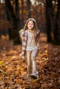 Young caucasian girl, candid autumnal portrait in the forest Royalty Free Stock Photo