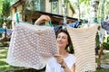 Candid real life portrait of young adult beautiful attractive caucasian woman hanging up fresh washed family clothes on birch tree Royalty Free Stock Photo