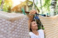 Candid real life portrait of young adult beautiful attractive caucasian woman hanging up fresh washed family clothes on Royalty Free Stock Photo