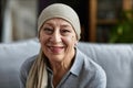 Candid senior bald woman smiling at camera and wearing makeup