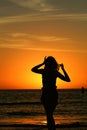 Candid Silhouette of a girl on beach with sun setting behind her Blind Pass Beach Florida Sanibel island