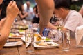 Candid waiter pouring water from bottle while people having dinne Royalty Free Stock Photo