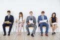 Candidates waiting for job interviews, full length, front